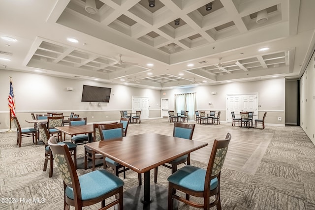 carpeted dining room with beamed ceiling, ceiling fan, and coffered ceiling