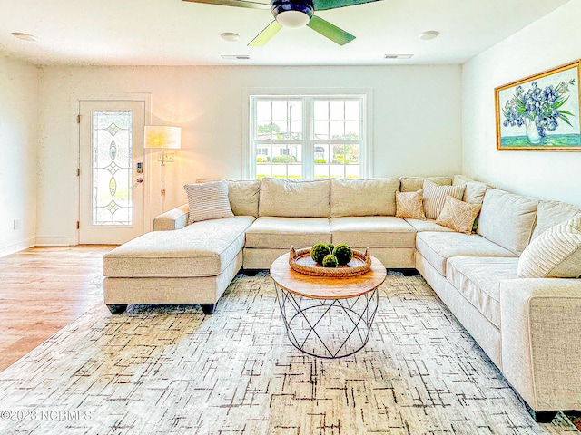 living room with light hardwood / wood-style floors and ceiling fan