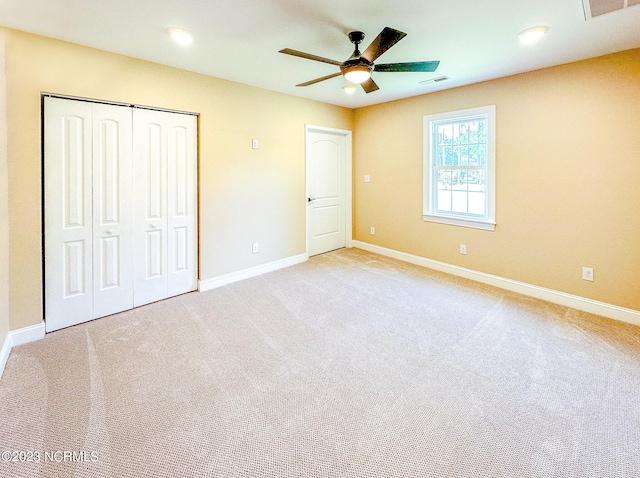 unfurnished bedroom featuring ceiling fan and light carpet