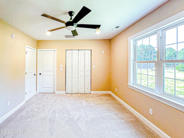 unfurnished bedroom with carpet and ceiling fan