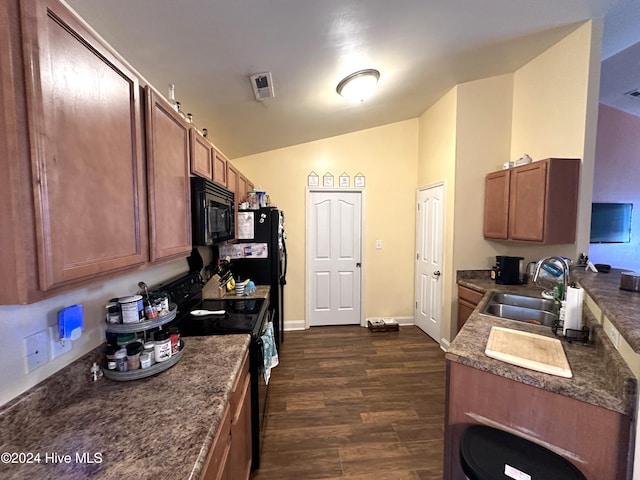 kitchen with sink, dark hardwood / wood-style floors, vaulted ceiling, and black appliances