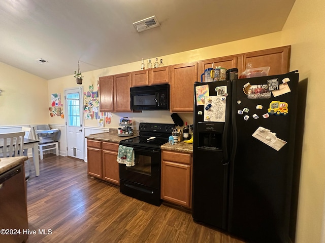 kitchen featuring black appliances and dark hardwood / wood-style flooring