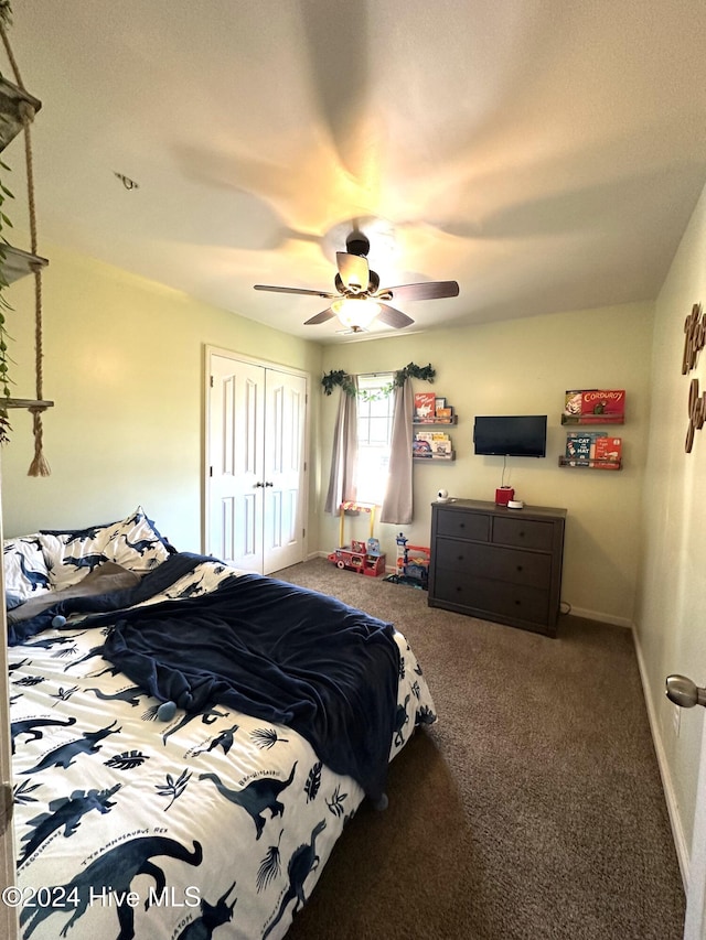 carpeted bedroom with ceiling fan and a closet