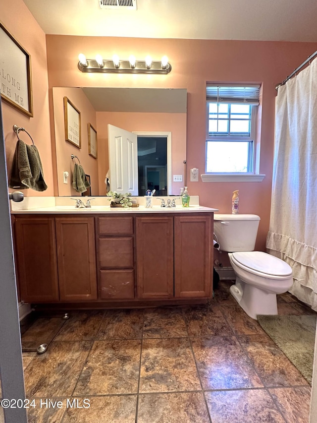 bathroom with vanity, toilet, and walk in shower