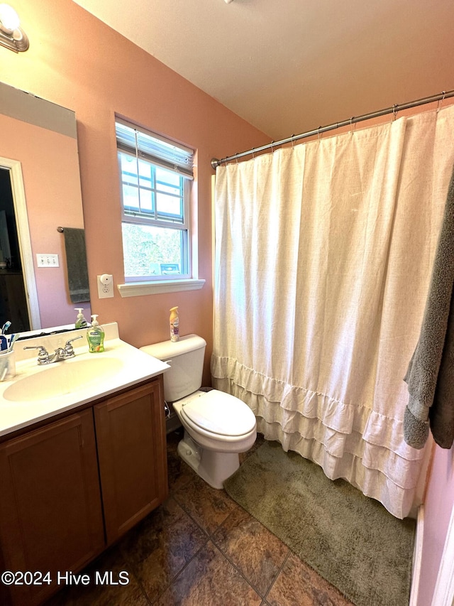 bathroom featuring a shower with shower curtain, tile patterned floors, vanity, and toilet