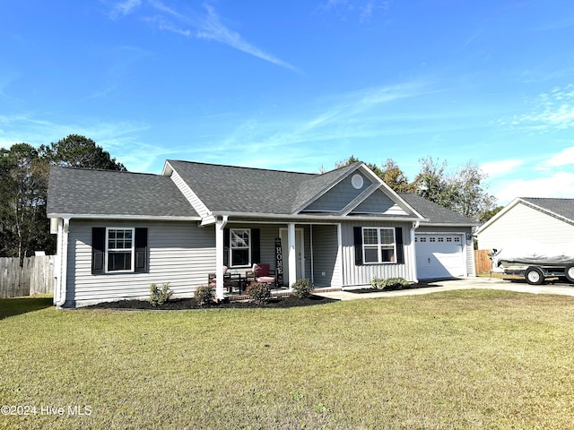 ranch-style house with covered porch, a garage, and a front yard