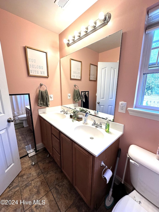 bathroom with vanity and toilet