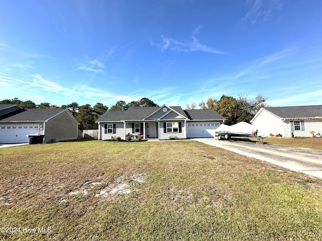 single story home featuring covered porch, a garage, and a front lawn