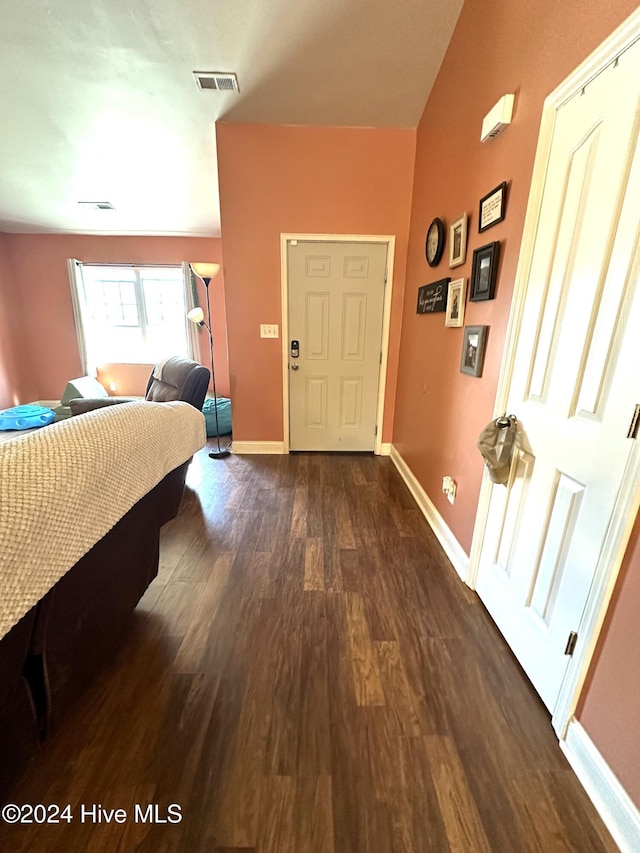 entryway with dark hardwood / wood-style flooring