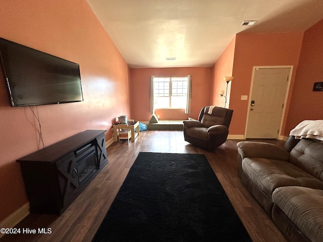 living room with wood-type flooring and vaulted ceiling