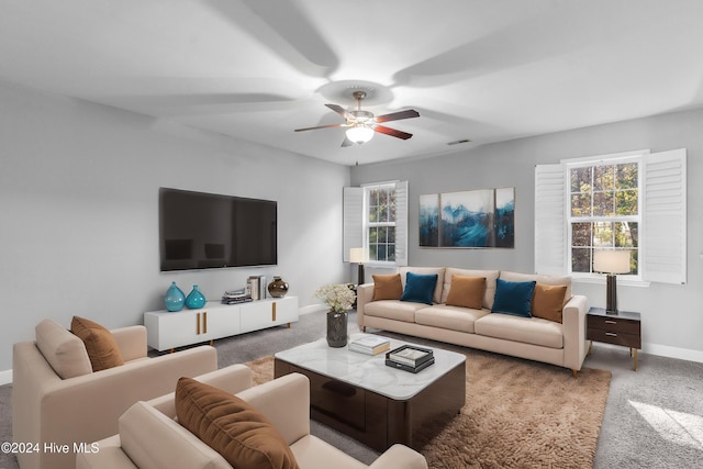 carpeted living room with ceiling fan and a healthy amount of sunlight