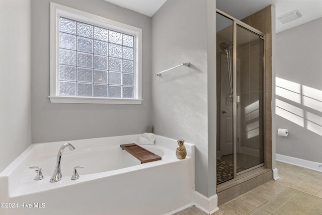 bathroom featuring separate shower and tub and tile patterned flooring