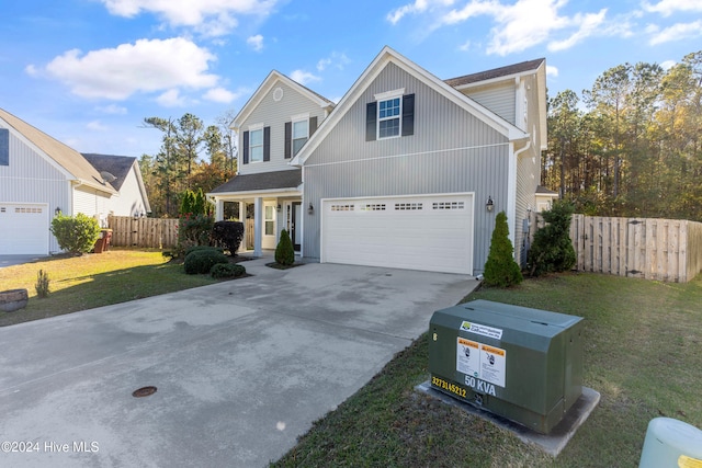 view of property with a garage and a front lawn