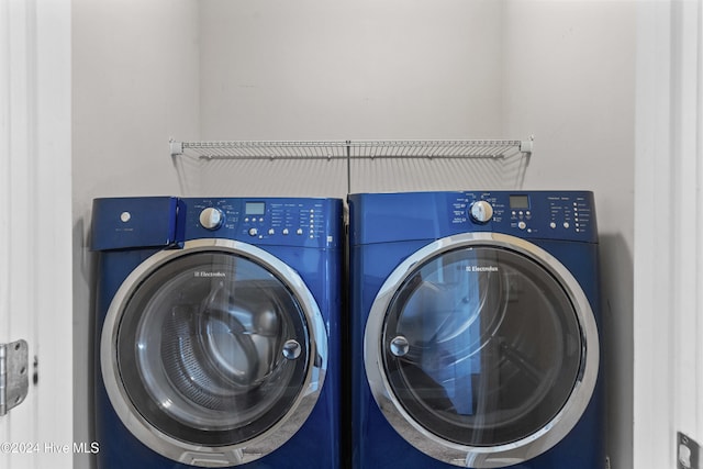 clothes washing area featuring separate washer and dryer