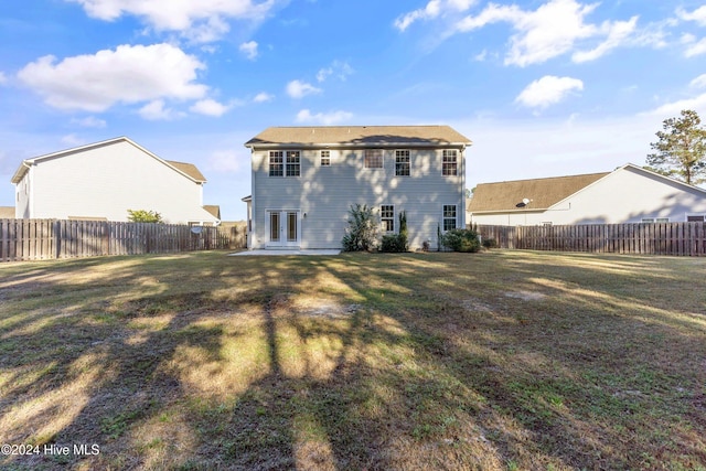 rear view of property with a yard and french doors