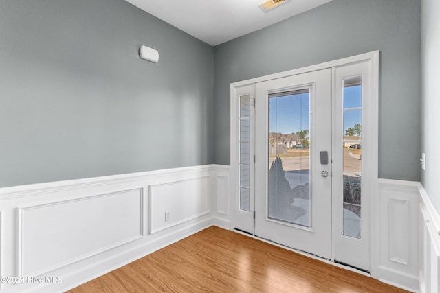 doorway to outside with wood-type flooring