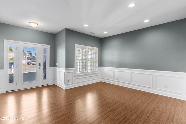 foyer featuring plenty of natural light and hardwood / wood-style flooring