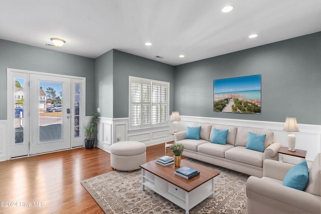 living room with light hardwood / wood-style flooring and a wealth of natural light