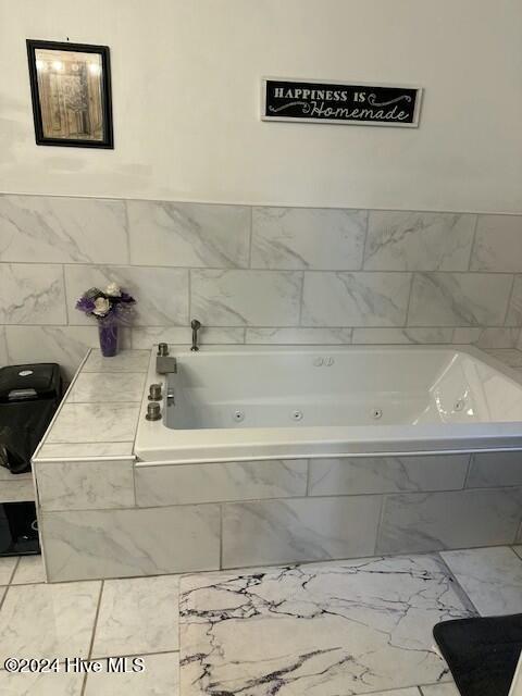 bathroom with tiled bath