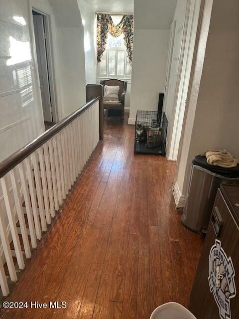 hallway with dark wood-type flooring