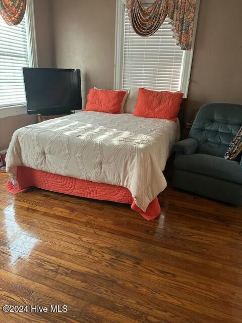 bedroom featuring dark hardwood / wood-style flooring