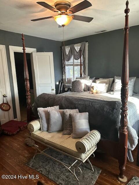 bedroom featuring ceiling fan and hardwood / wood-style flooring