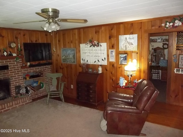 4271 Caratoke Hwy, Barco, NC 27917 - living room with wooden walls, a brick fireplace, ceiling fan, and carpet floors