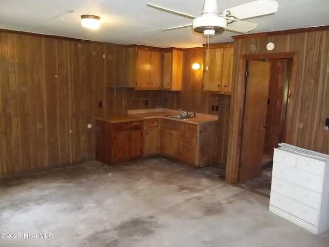 4271 Caratoke Hwy, Barco, NC 27917 - kitchen featuring wood walls, ceiling fan, concrete floors, brown cabinetry, and light countertops