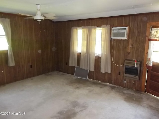 4271 Caratoke Hwy, Barco, NC 27917 - empty room featuring heating unit, wood walls, an AC wall unit, plenty of natural light, and ceiling fan