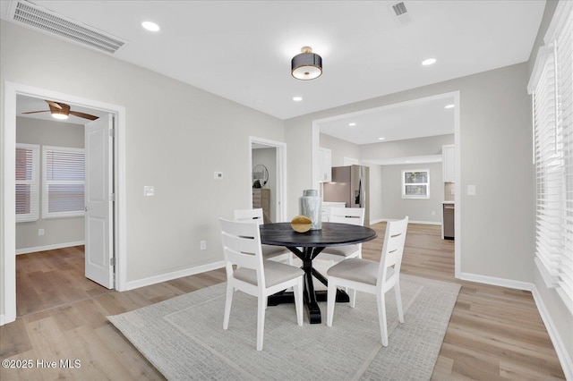 dining room with ceiling fan and light hardwood / wood-style floors