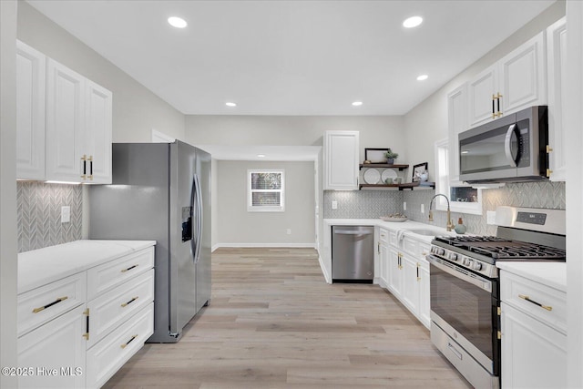 kitchen with white cabinets, sink, and stainless steel appliances