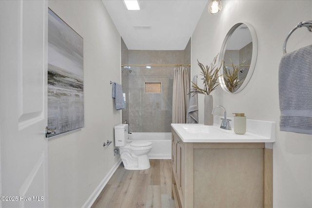 full bathroom with shower / tub combo, vanity, hardwood / wood-style flooring, and toilet