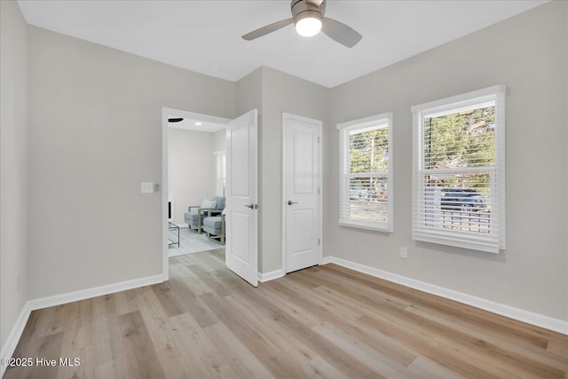 unfurnished room featuring ceiling fan and light wood-type flooring