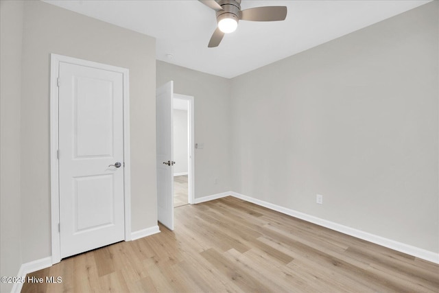 spare room featuring light hardwood / wood-style floors and ceiling fan