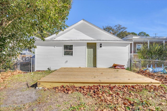 rear view of house featuring a wooden deck