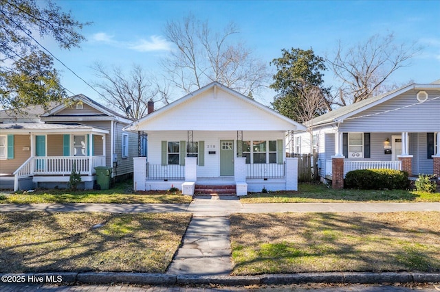 bungalow-style home with a front lawn