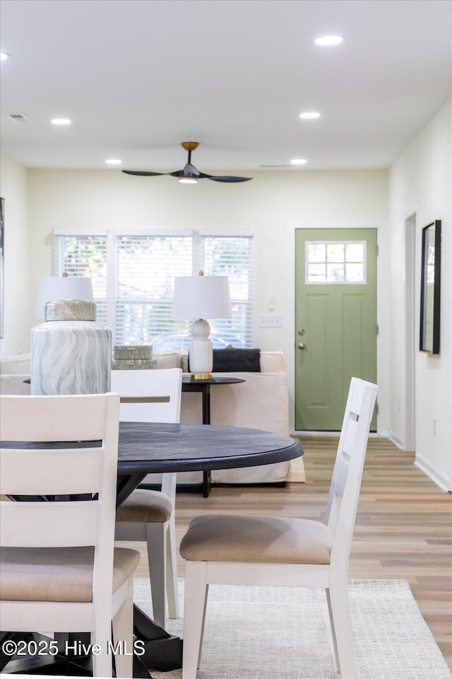 dining area with ceiling fan and light wood-type flooring