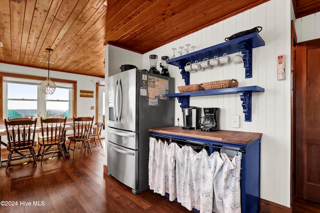 kitchen with stainless steel fridge, decorative light fixtures, wooden ceiling, dark hardwood / wood-style floors, and butcher block counters