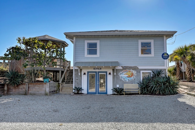 view of front property featuring french doors and a deck