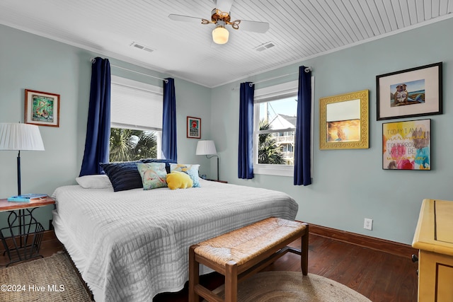 bedroom with ceiling fan, dark hardwood / wood-style floors, crown molding, and multiple windows