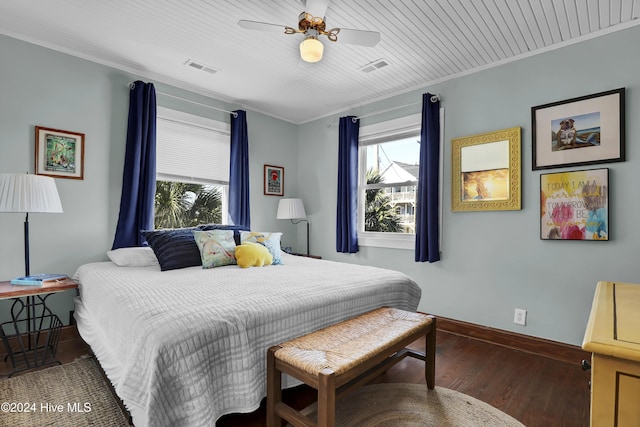 427 N Anderson Blvd, Topsail Beach, NC 28445 - bedroom featuring multiple windows, baseboards, wood finished floors, crown molding, and ceiling fan