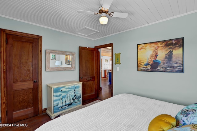 bedroom featuring dark hardwood / wood-style floors, ceiling fan, and ornamental molding