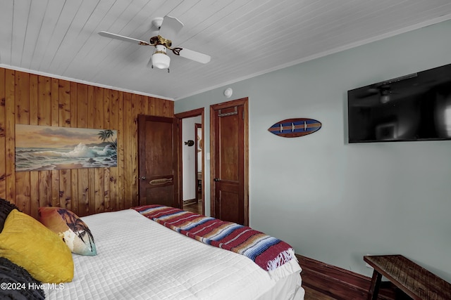 427 N Anderson Blvd, Topsail Beach, NC 28445 - bedroom with wooden walls, baseboards, ceiling fan, crown molding, and wood finished floors