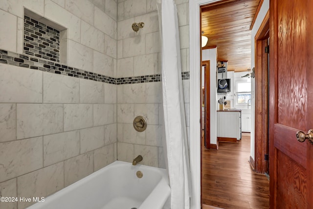 bathroom with wood-type flooring and shower / bathtub combination with curtain