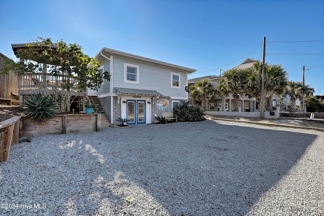 view of front property featuring french doors and a deck