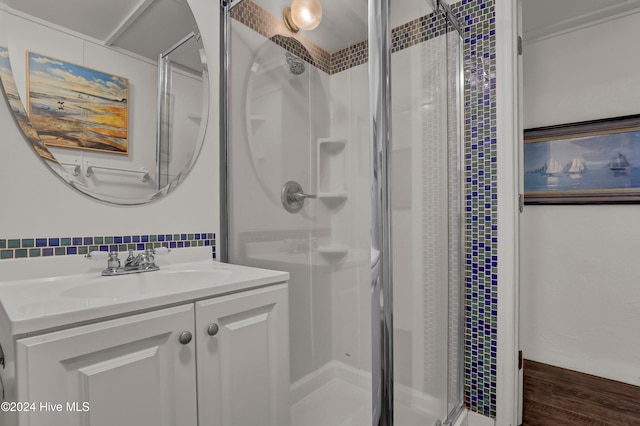 bathroom featuring hardwood / wood-style flooring, vanity, and walk in shower