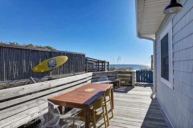 wooden terrace featuring a water view