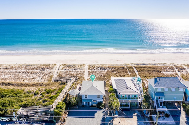 birds eye view of property with a water view and a view of the beach