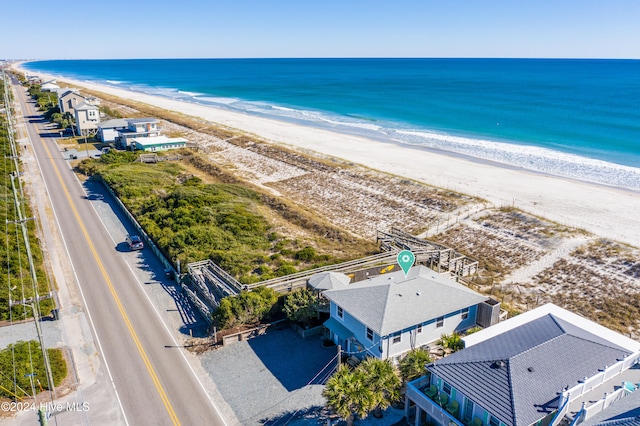 birds eye view of property featuring a water view and a view of the beach