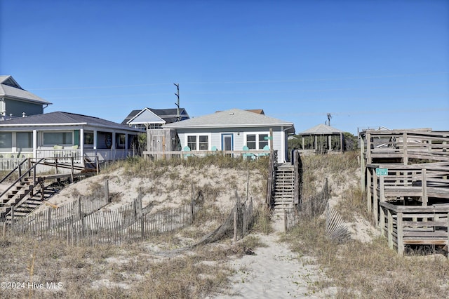 427 N Anderson Blvd, Topsail Beach, NC 28445 - view of front of house featuring stairs and roof with shingles
